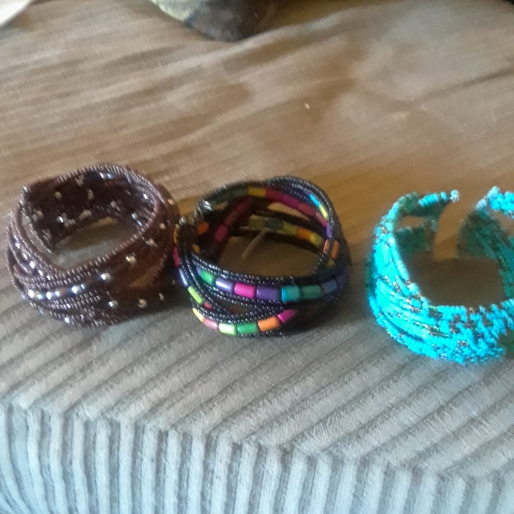 Three cuff bracelets.